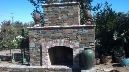 A picture of an outdoor stacked stone fireplace that was built in Carmichael, CA