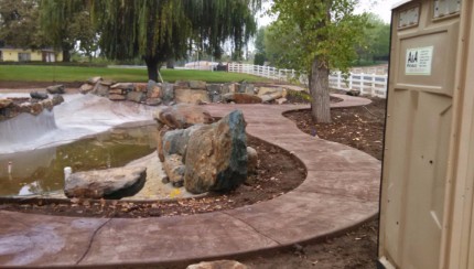 Picture of a concrete walkway going around a pond located in Carmichael CA