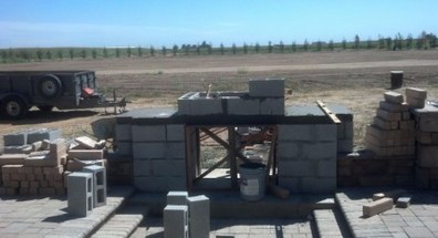 A picture of the beginning of a concrete fireplace build. Just the foundation of the concrete blocks so far